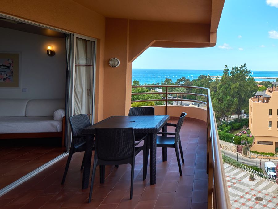 Balcony with table and chairs overlooking Vilamoura at Dom Pedro Portobelo Hotel