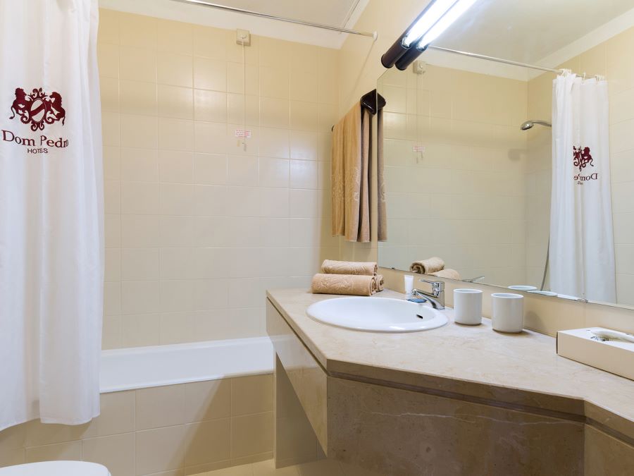 Shower with sink, and wash basin in bathroom at Dom Pedro Portobelo Hotel in Vilamoura