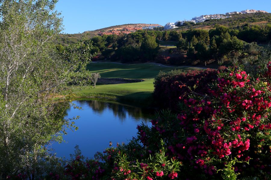 Hole 1 at Dona Julia Golf Club in the Costa Del Sol with a lake protecting the fairway