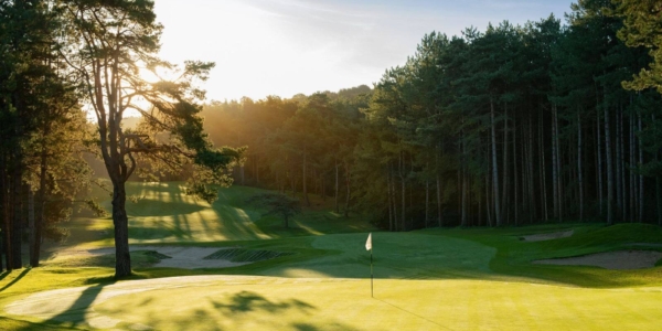 Sunrise over Hardelot's Les Dunes Golf Course on hole 1, with trees protecting the green fairway