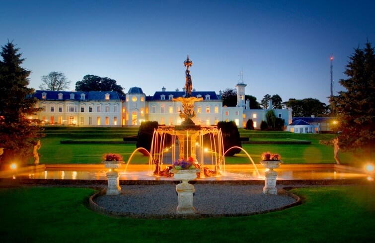 Illuminated fountain in the gardens of The K Club Resort in the evening