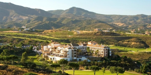 Ariel photo of La Cala Golf Resort surrounded by golf courses with Sierra de Mijas in the background