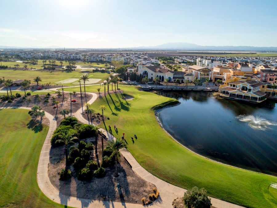 Blue lake to the right of the green fairway at La Torre in Spain