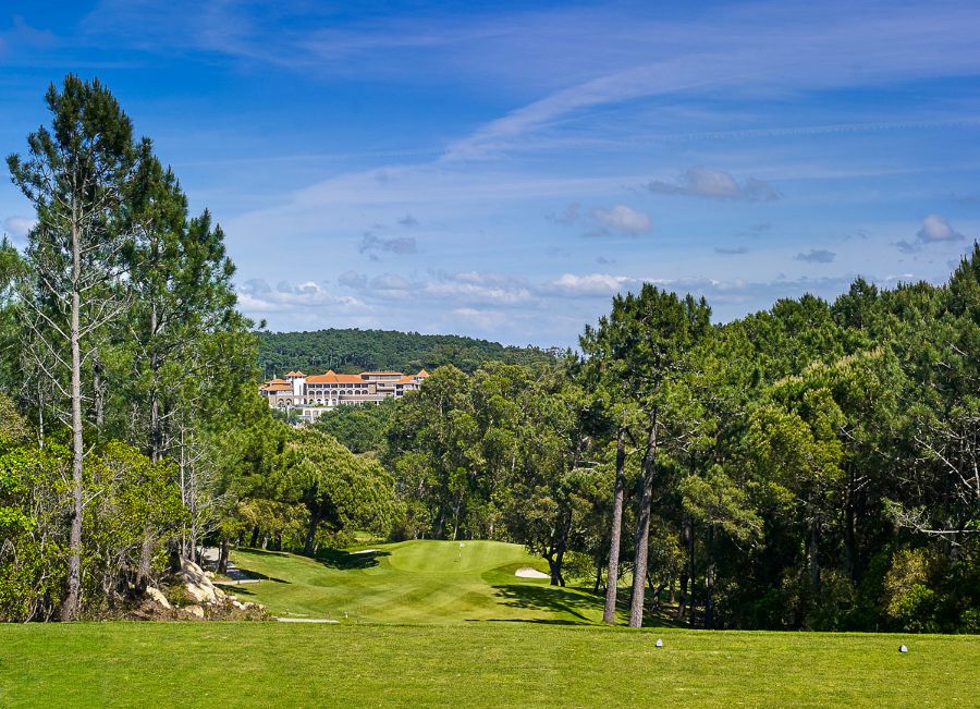 Blue sky over the fairway with the five-star hotel in the distance at Penha Longa Golf Course