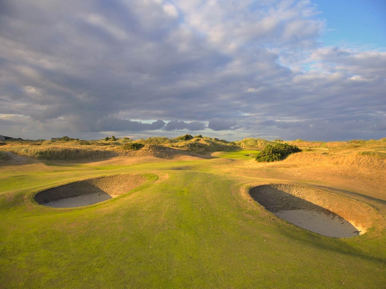 Golf course at Portmarnock Hotel and Golf Links with two bunkers and fairway