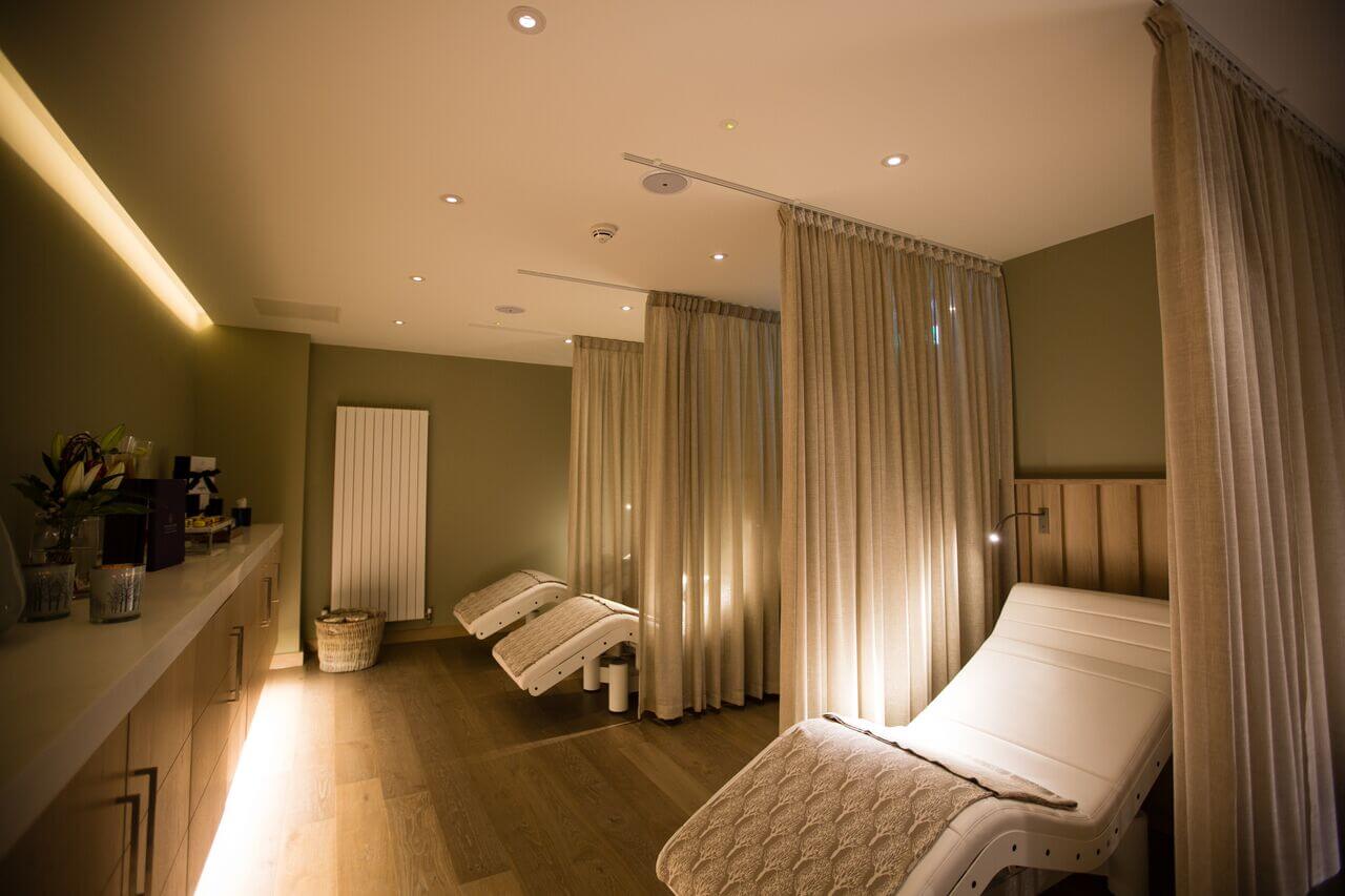 Candlelit treatment room with three treatment tables in the Spa at Portmarnock Hotel and Golf Links