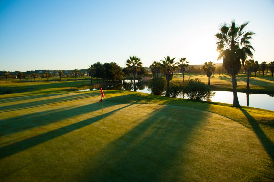 Putting green on hole with red flag at Salgados Golf Course
