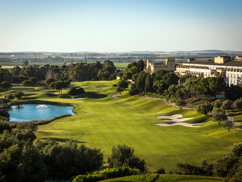 Lake with fountain and golf course fairway at Montecastillo Golf Resort