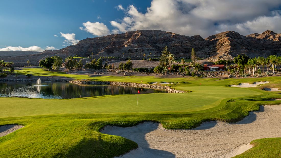 Anfi Tauro Golf Club in Gran Canaria, Spain, with large rock in the background and sandy bunker in foreground