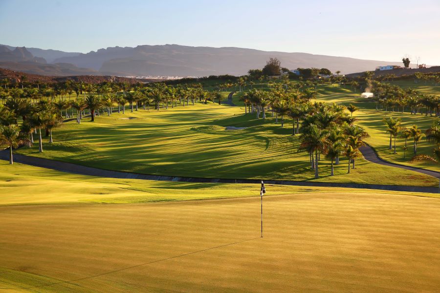 Flag on the green with mountains in the background at Melonares Golf Course in Spain's Gran Canaria