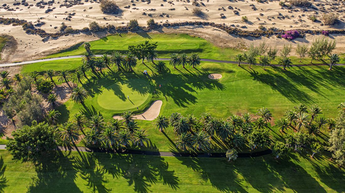 Birds eye shot of Maspalomas Golf in Gran Canaria with trees lining the fairway