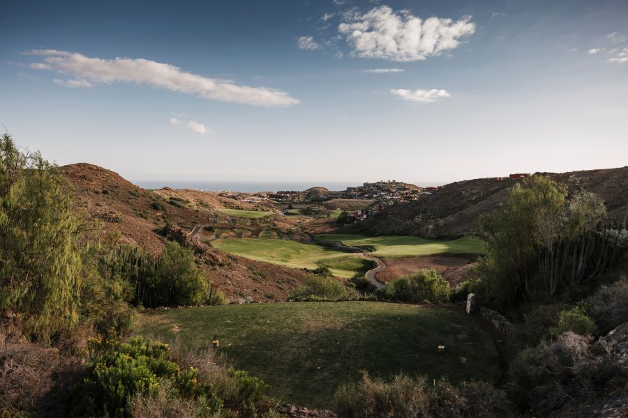 View from the tee with blue sky and white clouds at Salobre Golf in Gran Canaria