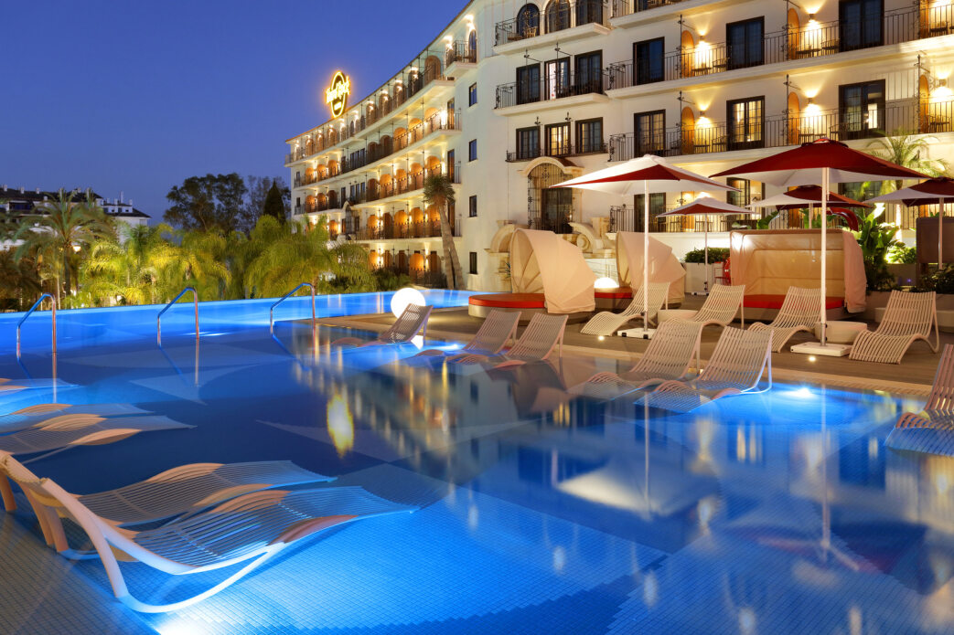 Sun loungers in the outdoor pool at night at Hard Rock Hotel Marbella