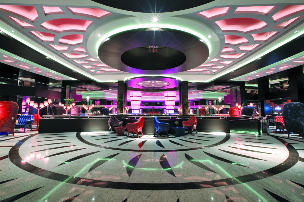 Bar with blue and red leather chairs at Cornelia Diamond Resort