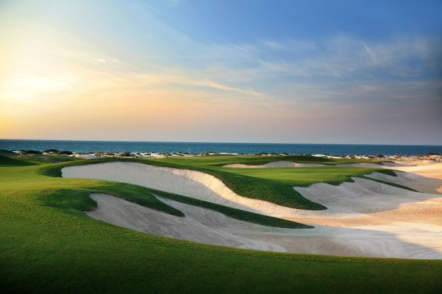 Bunkers with the sea in the distance at Saadiyat Beach Golf Club