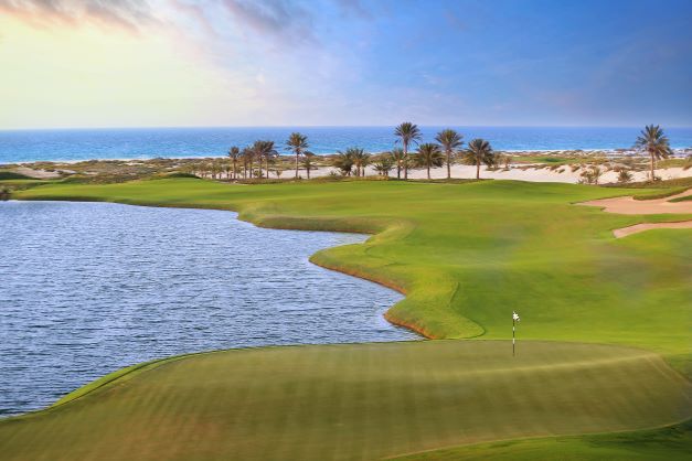 Saadiyat Beach Golf Club with sea in the distance and lake to the left of the fairway