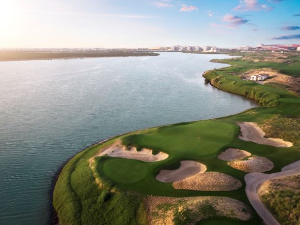 Yas Links Golf Club with bunkers protecting the green, surrounded by sea
