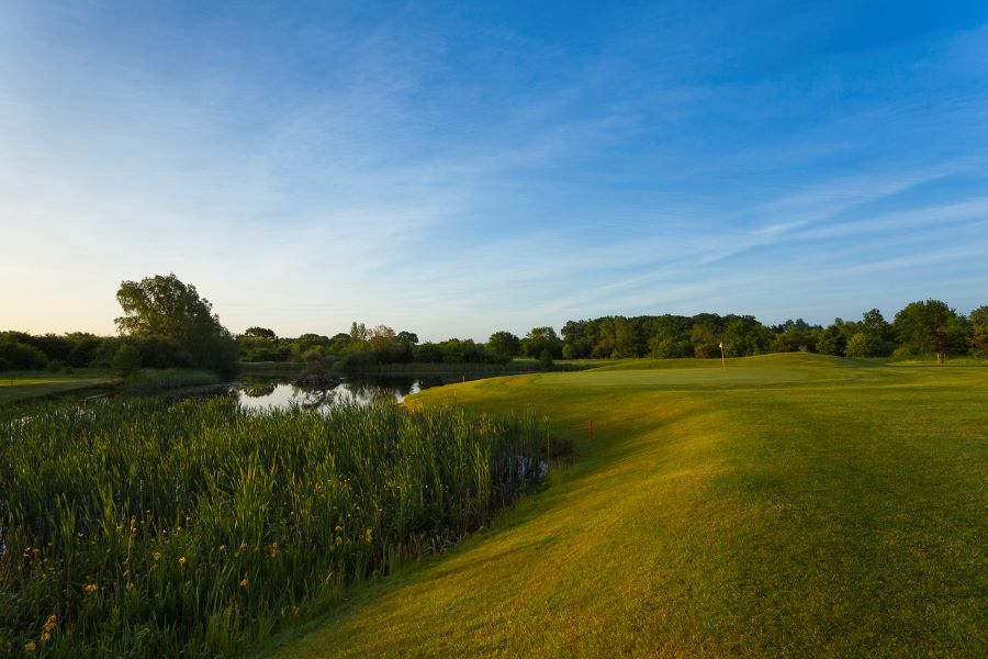 Green fairway with lake to the left at Belton Woods Hotel, Spa And Golf Resort