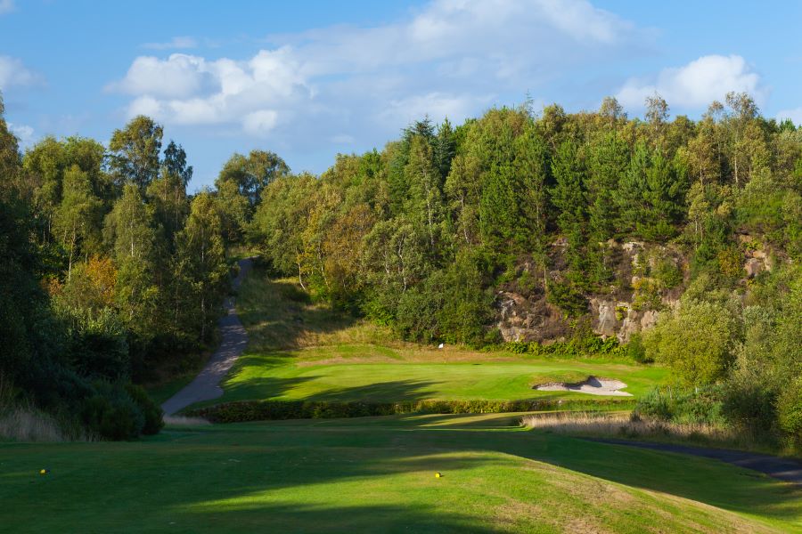 Large trees behind the green at Glasgow Westerwood Hotel, Spa & Golf Resort
