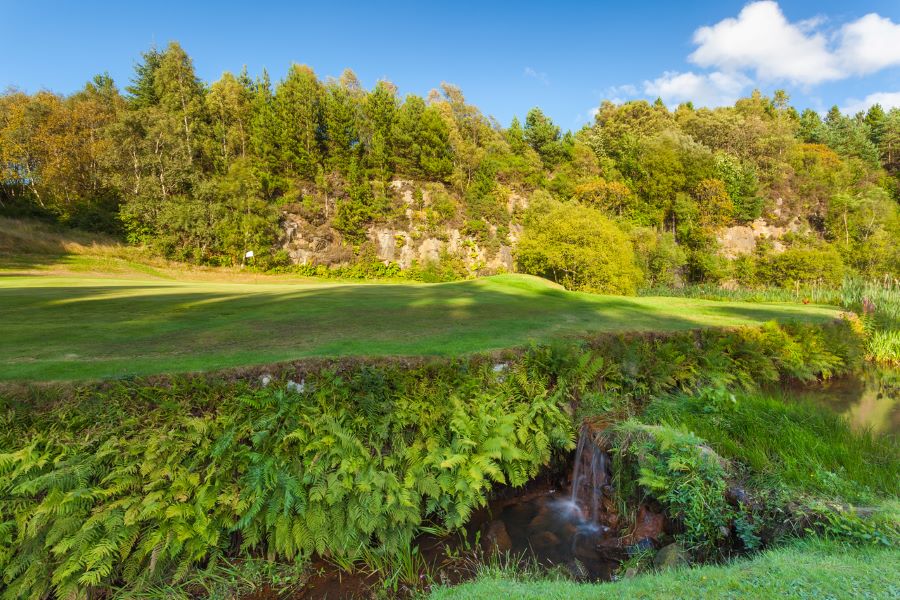 Blue sky over the course with trees in the background at Glasgow Westerwood Hotel, Spa & Golf Resort