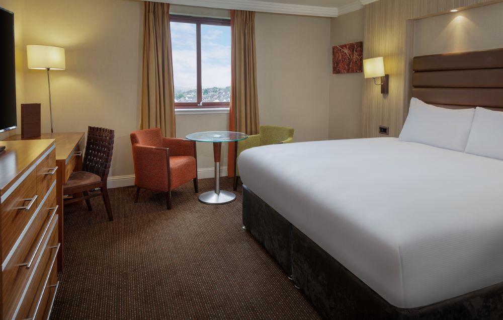 Double bed and chair in the bedroom at Glasgow Westerwood Hotel, Spa & Golf Resort