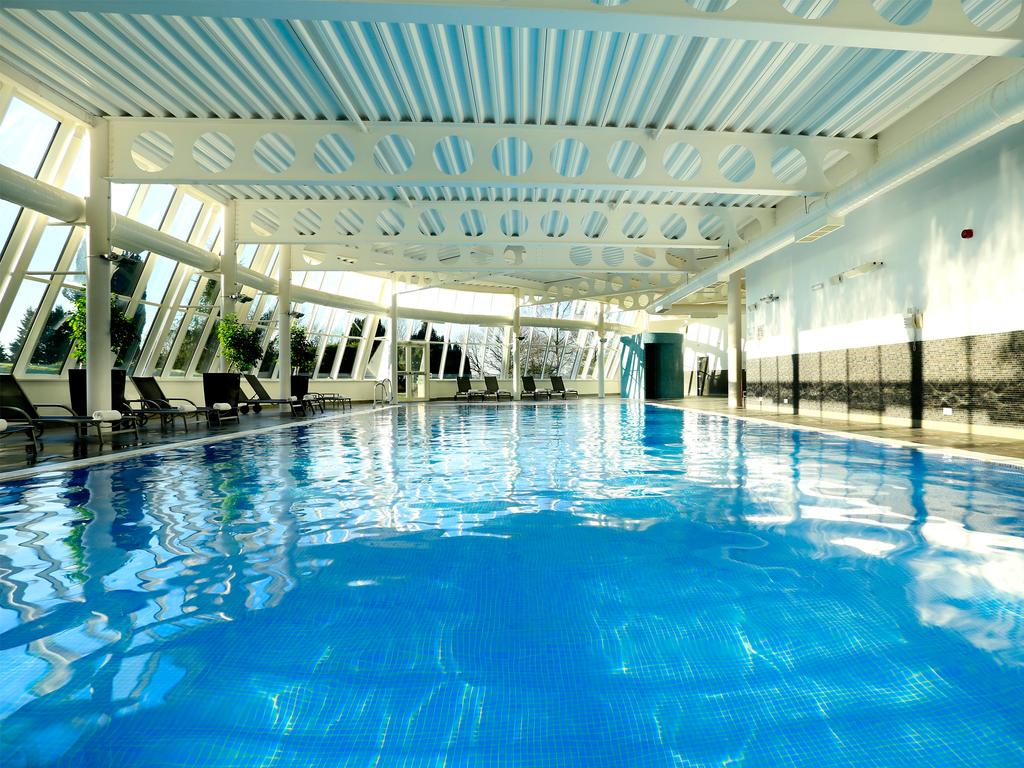 Indoor swimming pool and loungers at MacDonald Portal Hotel Golf And Spa
