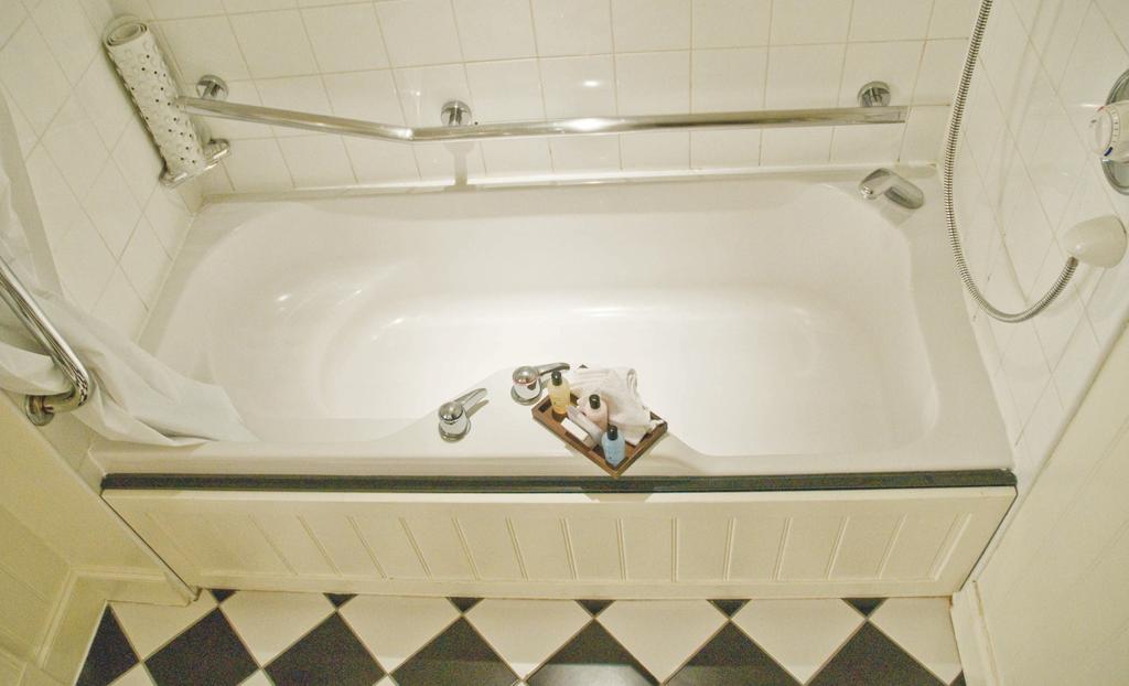 Bathroom at Macdonald Hill Valley Golf And Spa with toiletries resting on the bath tub
