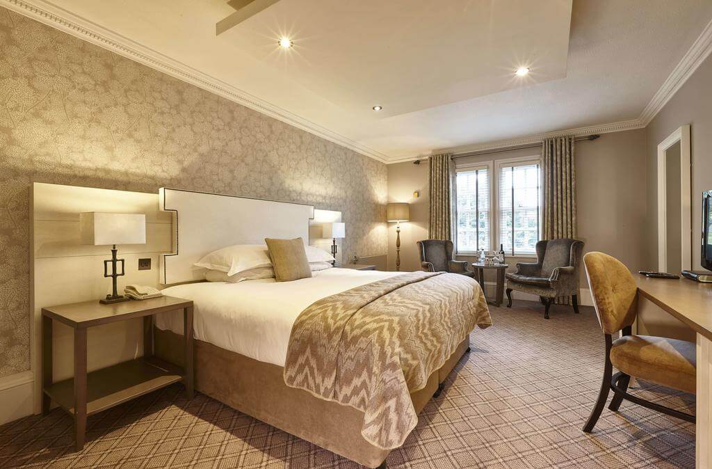 Double bedroom with decorative furniture at Oulton Hall Golf Hotel And Spa