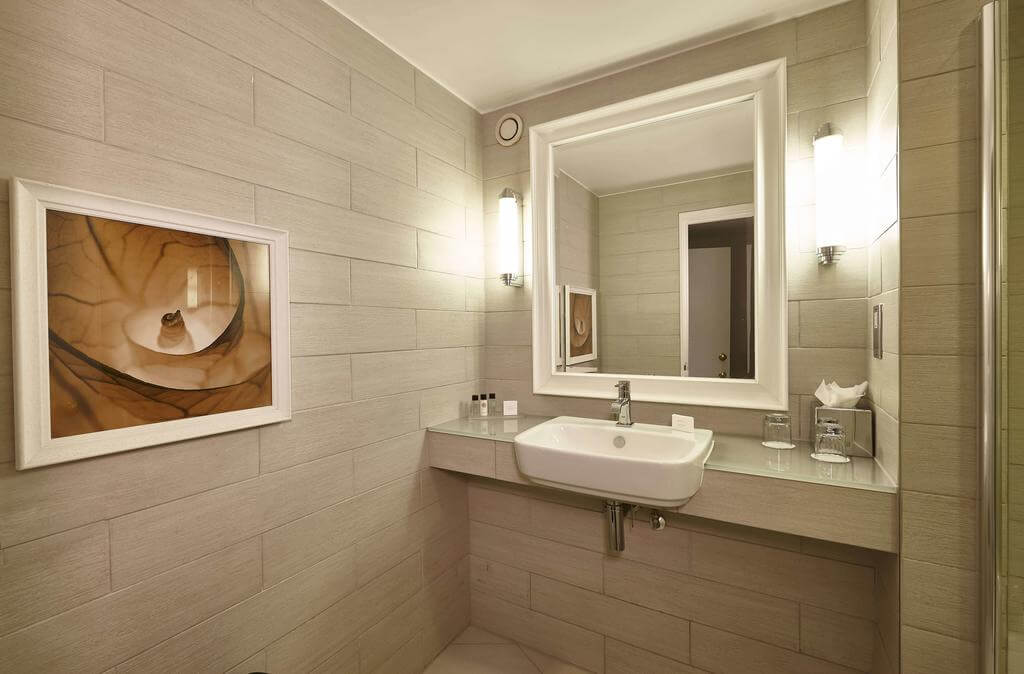 Bathroom featuring artwork and a sink with mirror at Oulton Hall Golf Hotel And Spa