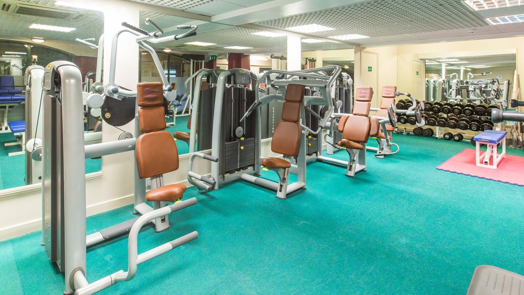 Gym with resistance machines and free weights at Hellidon Lakes Golf & Spa Hotel
