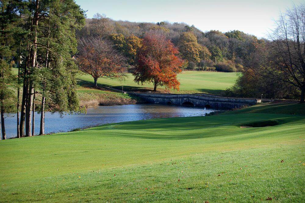 Golf course with bridge over river at Heythrop Park Golf Resort