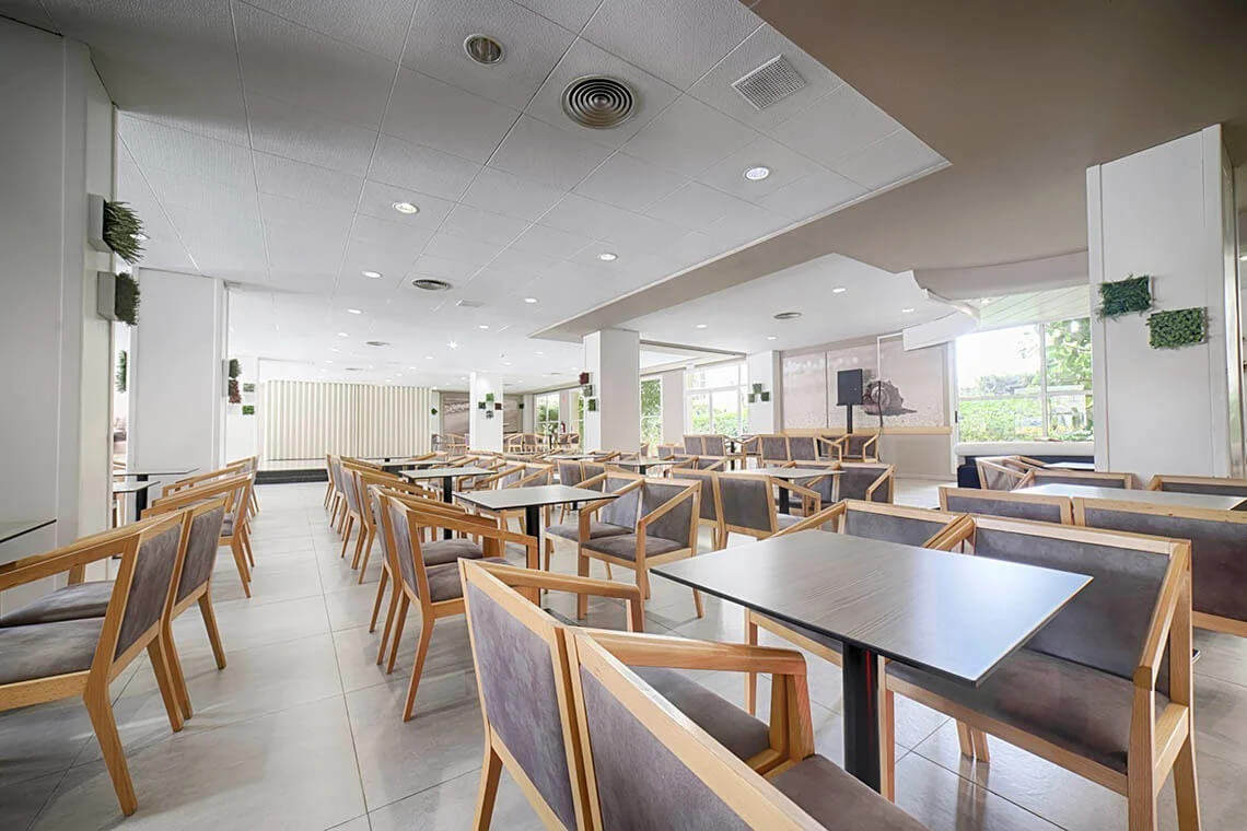 Dining room in restaurant at Ohtels Belvedere with grey chairs and tables