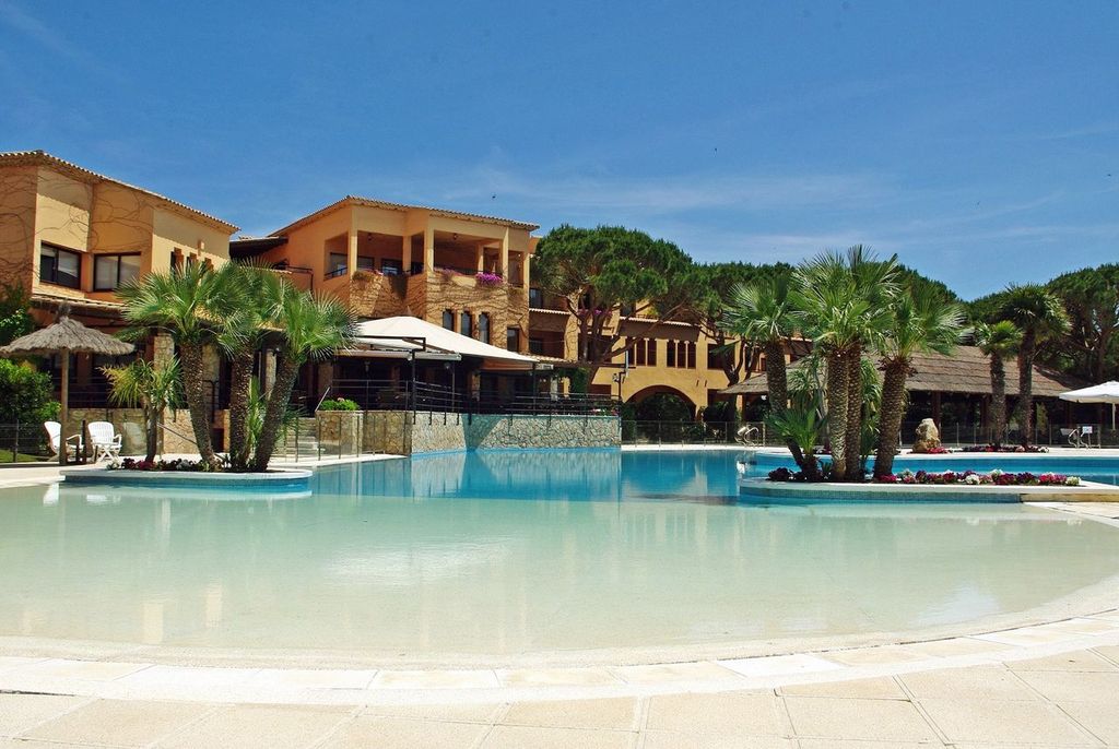 Swimming pool with trees at La Costa Golf and Beach Resort