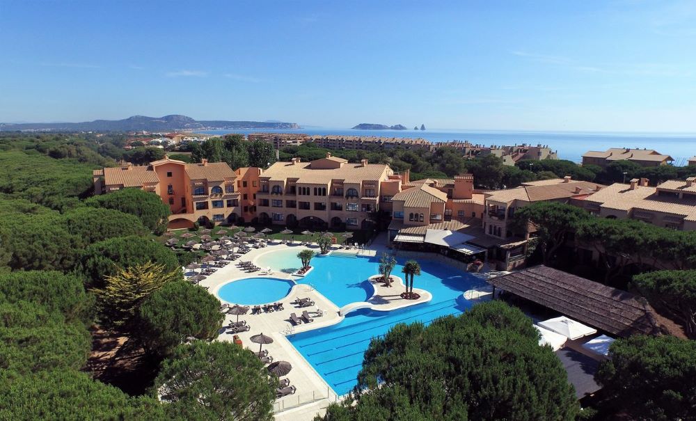 La Costa Golf and Beach Resort with swimming pool in foreground and trees surrounding