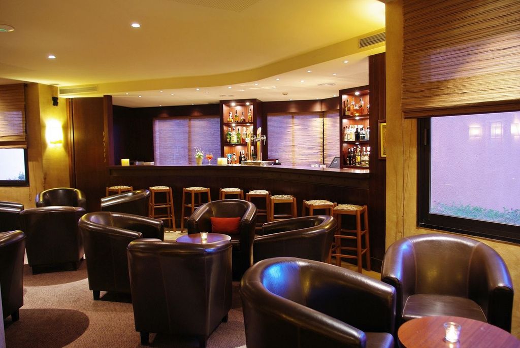 Bar with leather seats at La Costa Golf and Beach Resort