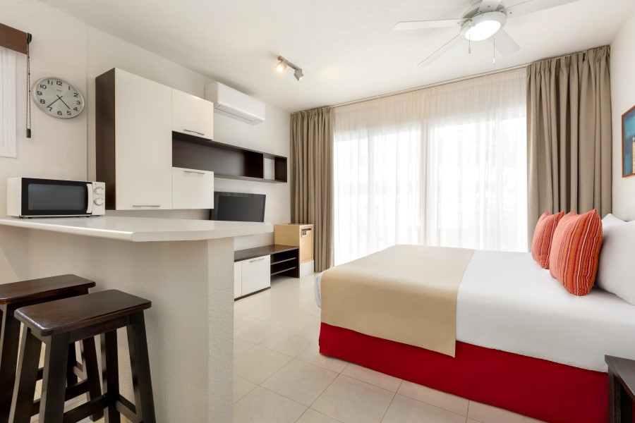 Studio apartment with television, kitchenette, bar stools and balcony at Wyndham Residences Golf del Sur in Tenerife