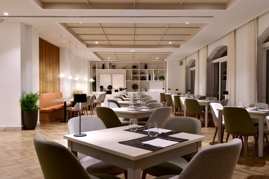 Tables and chairs set for guests to dine at Dolce by Wyndham CampoReal Lisboa