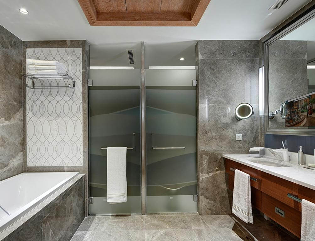 Bathroom with bath tub, sink and separate shower cubicle at Regnum Carya Golf And Spa Resort