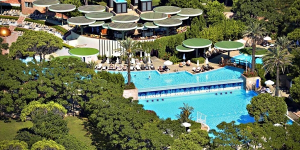 Gloria Verde Resort from the air with the swimming pool surrounded by trees