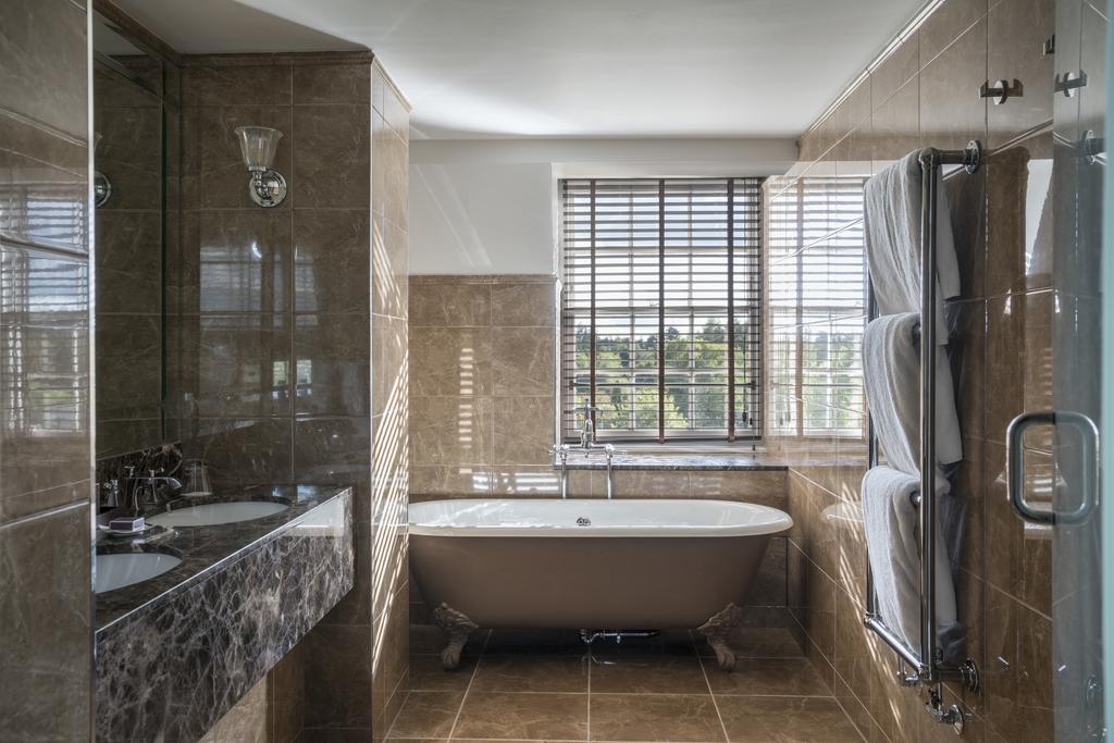 Bathroom with twin sinks and bath tub at Gleneagles Golf Resort