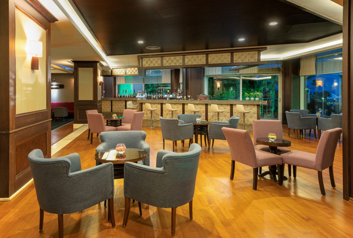 Pink and blue seats in bar at Kaya Belek Hotel