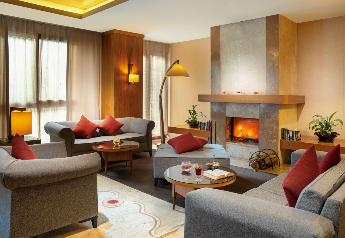 Seating area by fire in bar at Kaya Belek Hotel