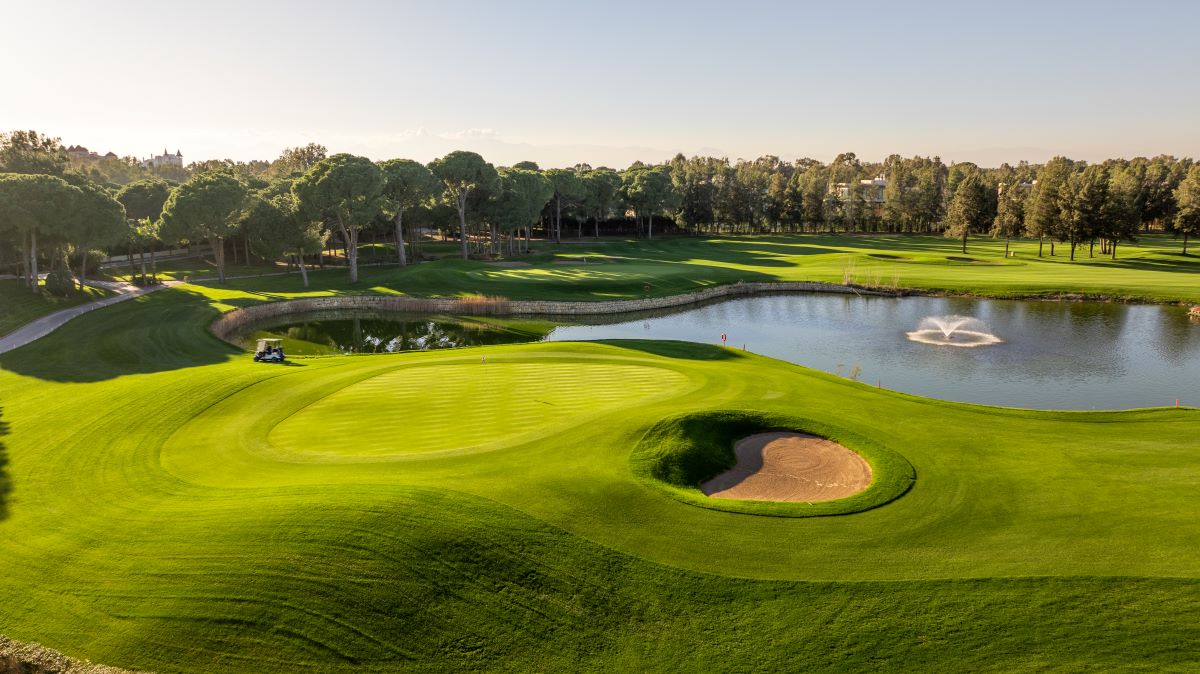 Lake in the distance of the green, with bunker to the right of Kaya Palazzo Golf Club