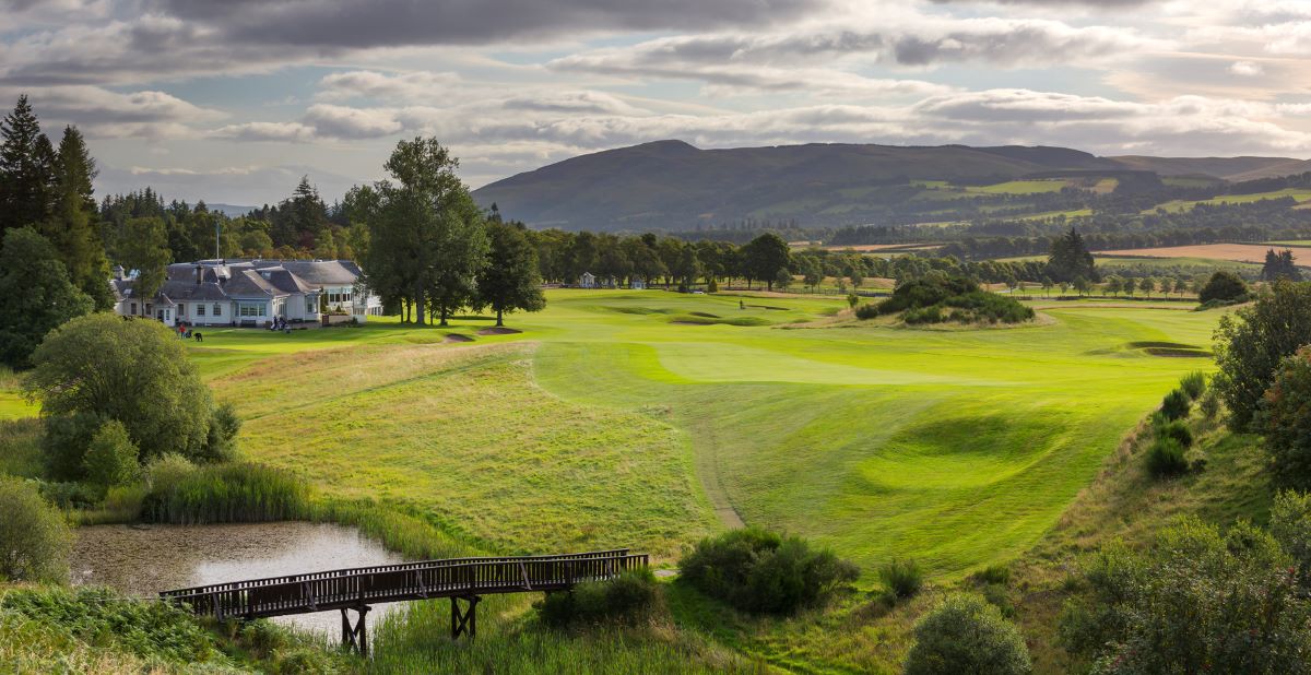 Putting green with trees and mountain in the distance at The Gleneagles Hotel