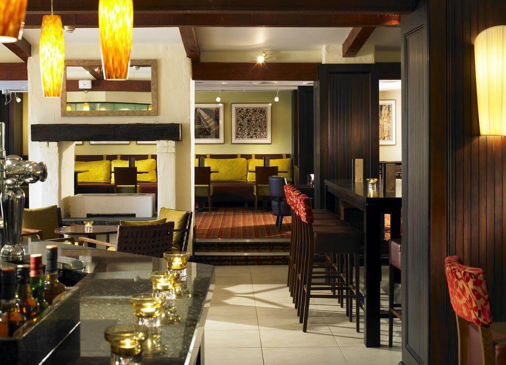 Bar and restaurant with candles placed on tables at Forest of Arden Marriott Hotel And Country Club