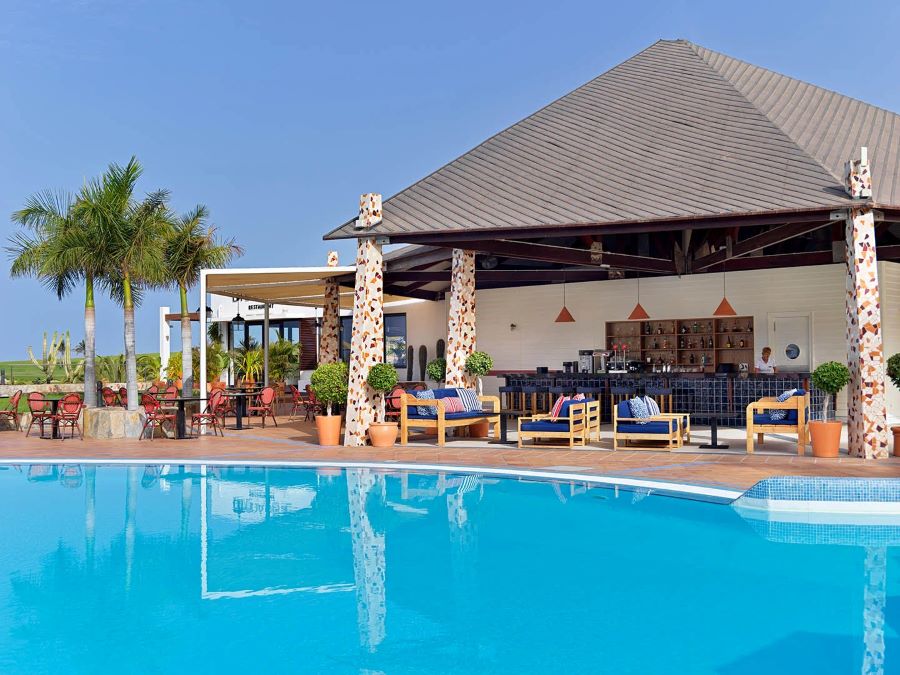 Pool bar with sun loungers at H10 Playa Meloneras Horizons Collection in Gran Canaria