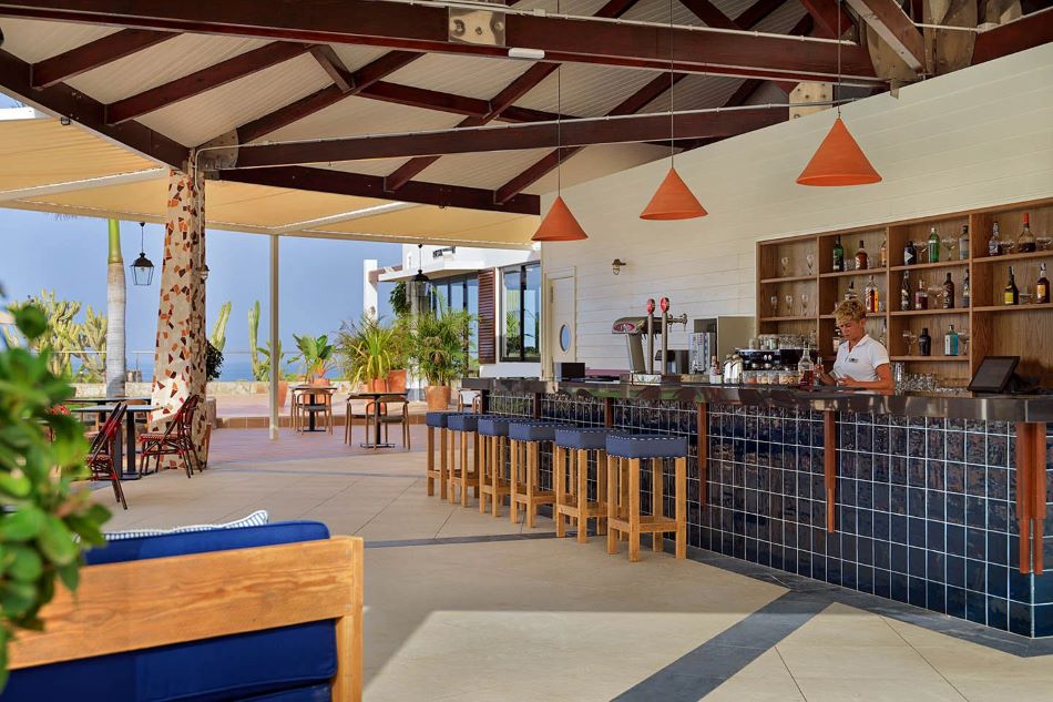 Bar stools by the bar which is outside under a canopy at H10 Playa Meloneras Horizons Collection