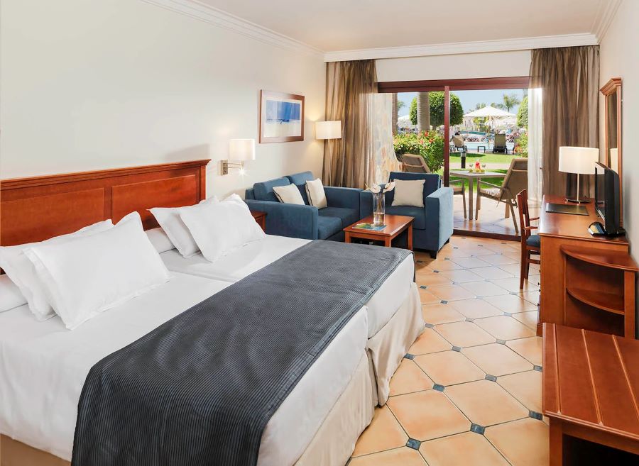 Bedroom with sofa in room at H10 Playa Meloneras Horizons Collection