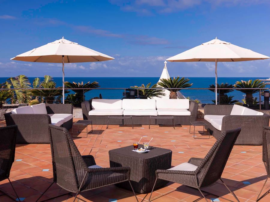 Sun terrace with parasols over the furniture at H10 Playa Meloneras Horizons Collection