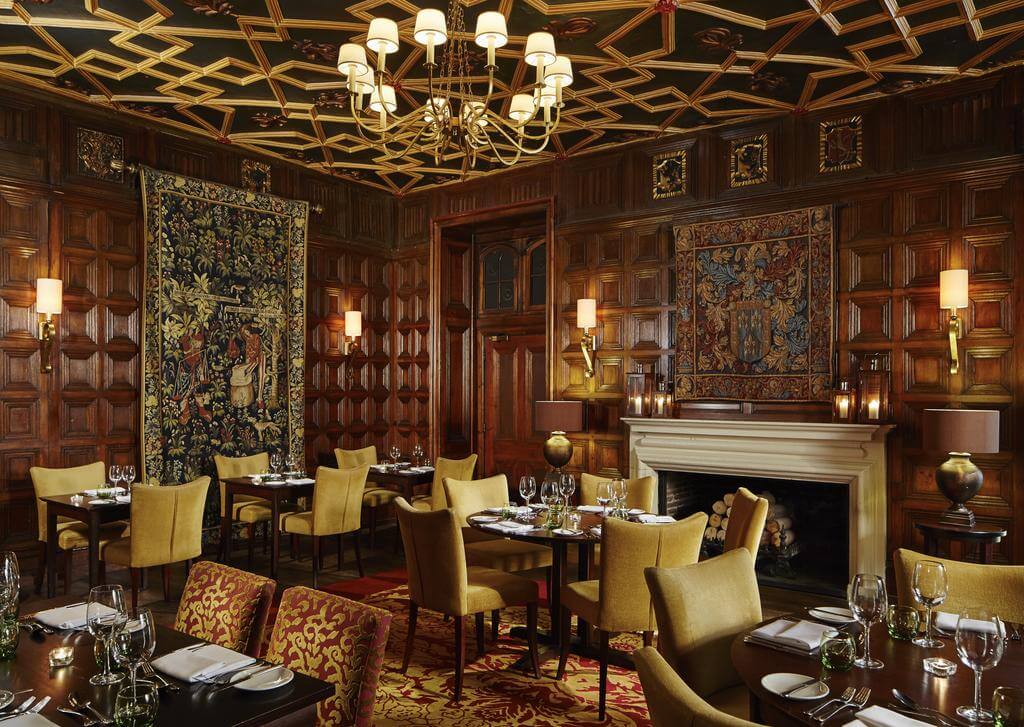 Formal dining room at St Pierre Marriott Hotel and Country Club with wood panelled walls and open fire